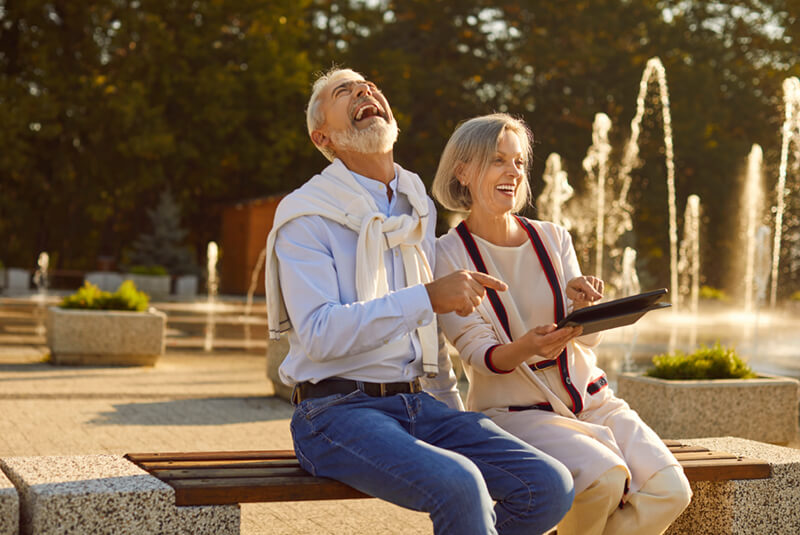 Happy Couple Sitting at a Bench