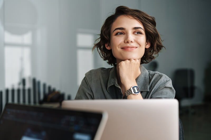 Person smiling on her computer