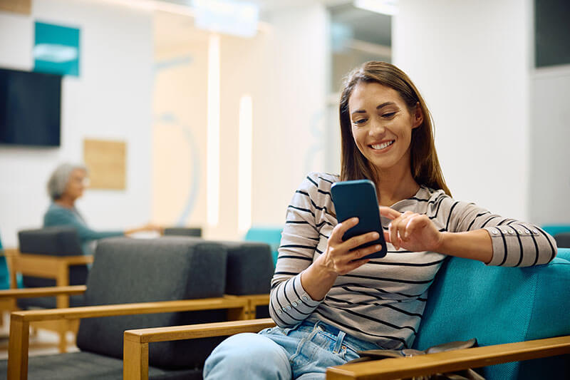 Woman looking at her phone in a waiting room