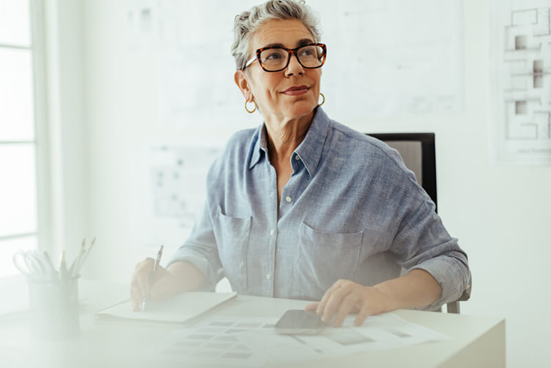 Woman writing at her desk